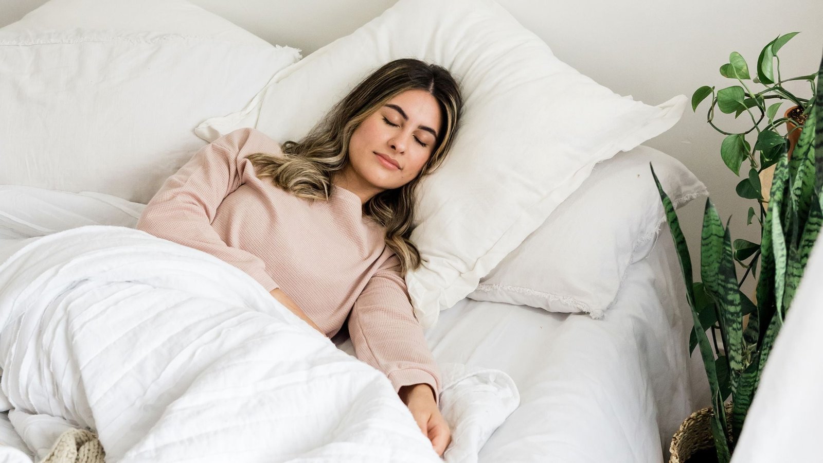 A person enjoying a restful night's sleep, illustrating the goal of using ear seeds for insomnia relief.