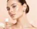 A woman with radiant skin wearing a crystal ear seed as part of her holistic skincare routine.