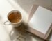 A soothing setup for digestive wellness featuring a warm cup of herbal tea and a LINGLONG JUHUO gold ear seed kit.