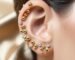 An elegant ear curation featuring a mix of gold and crystal ear seeds by LINGLONG JUHUO.